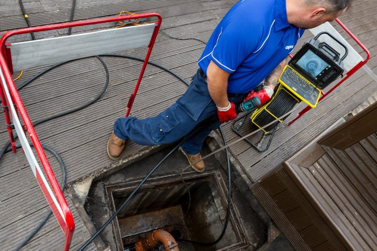 Coring and jetting a drain blocked with scale