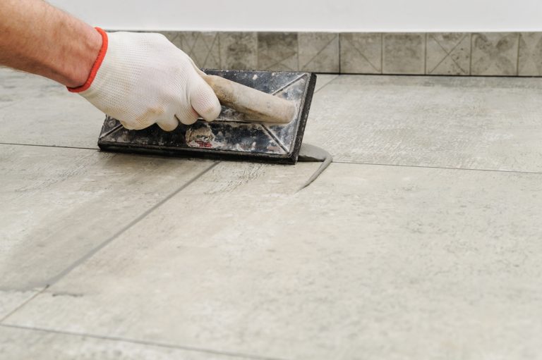 Grouting floor tiles in a bathroom