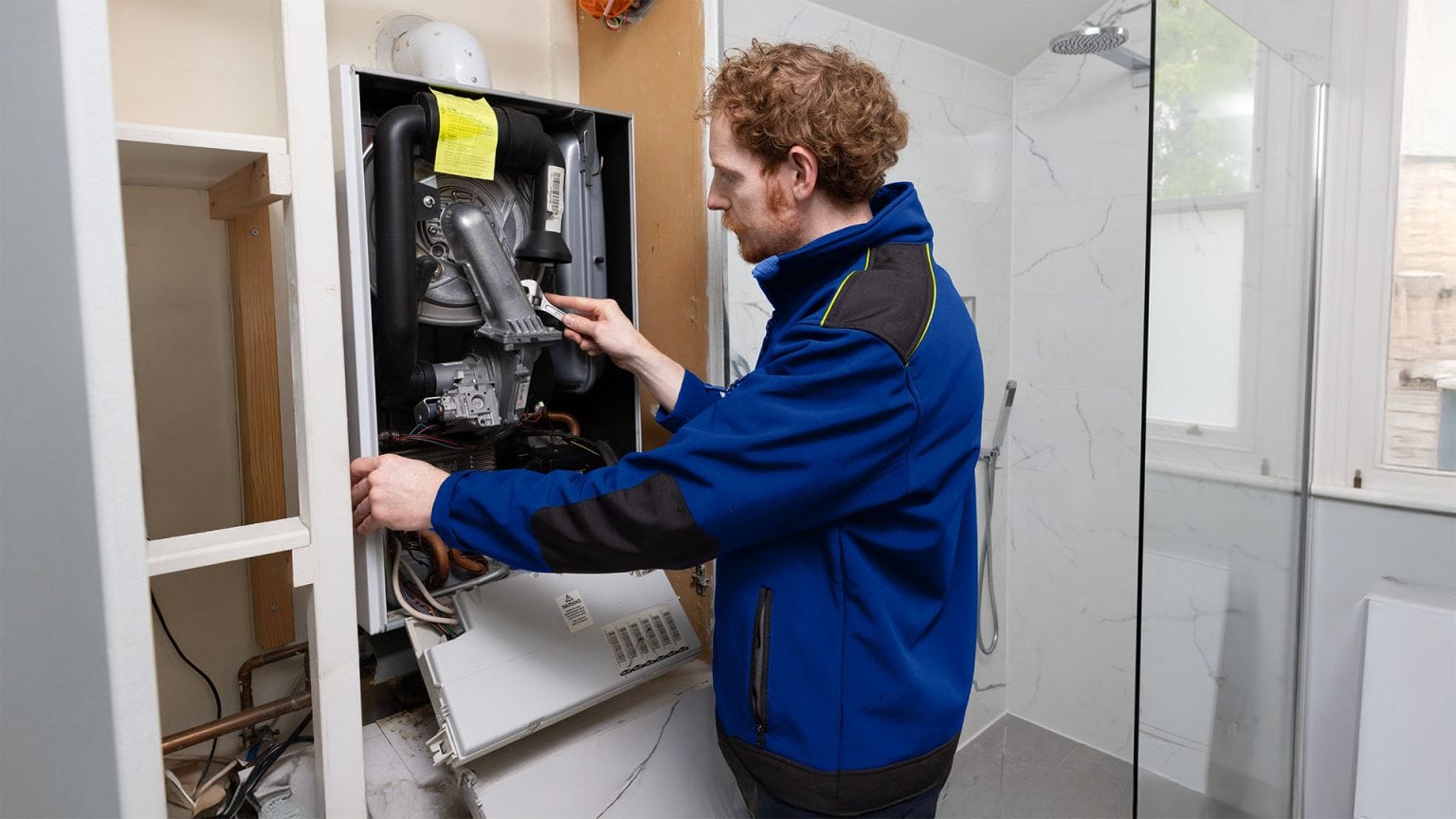 An Aspect gas engineer repairing a domestic gas boiler