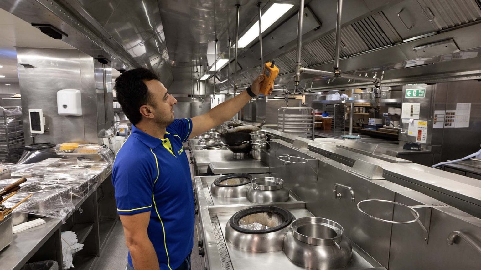 An Aspect gas engineer doing a CP42 gas safety certificate in a commercial kitchen.
