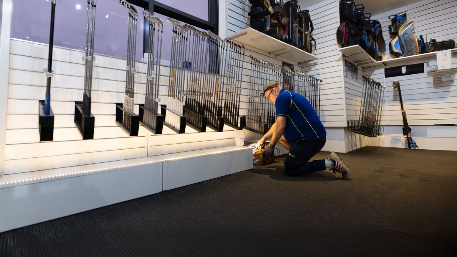 An Aspect electrician is testing an LED lighting installation in a retail shop.
