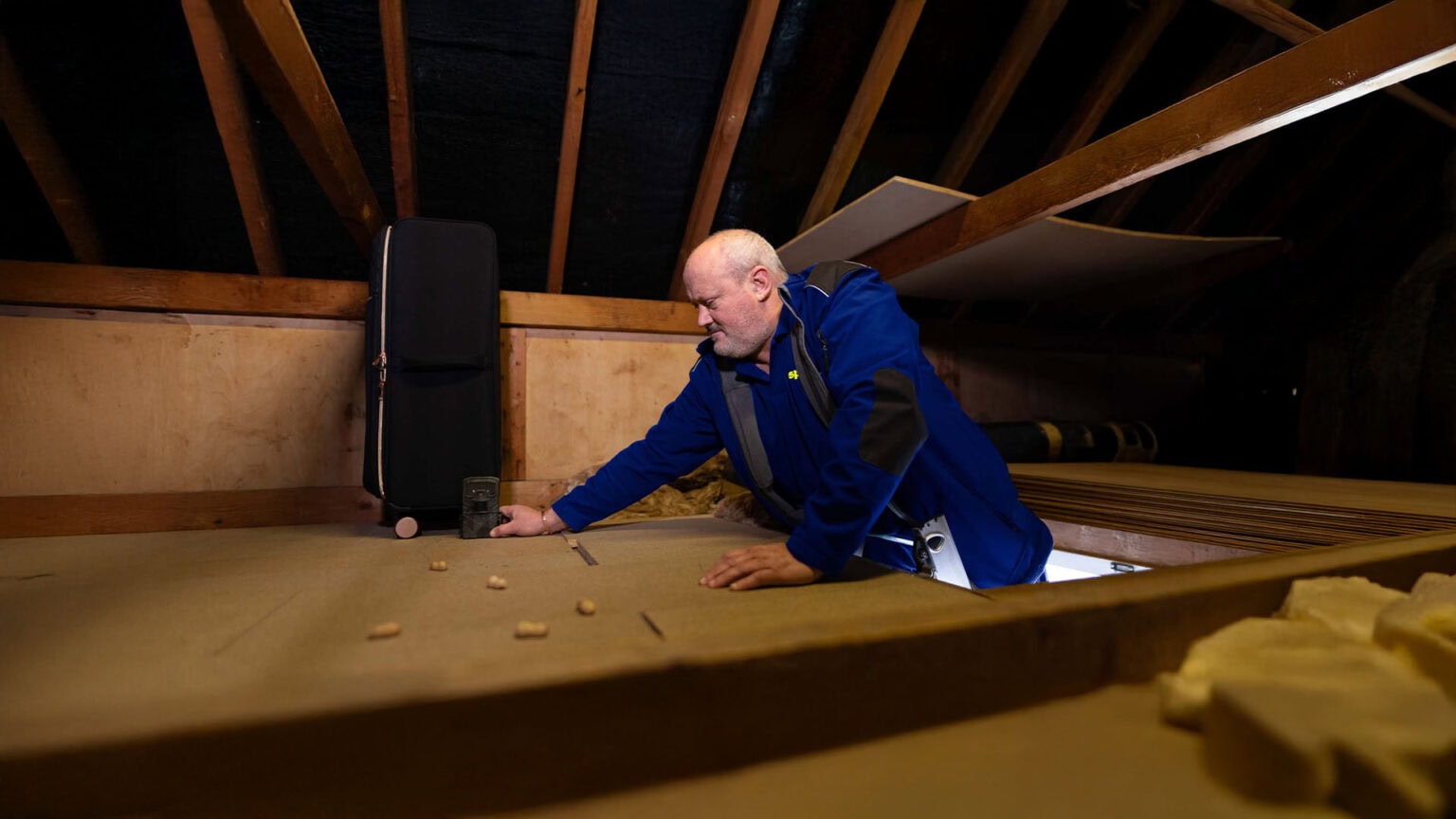 An Aspect pest controller sets a motion sensor camera in a loft