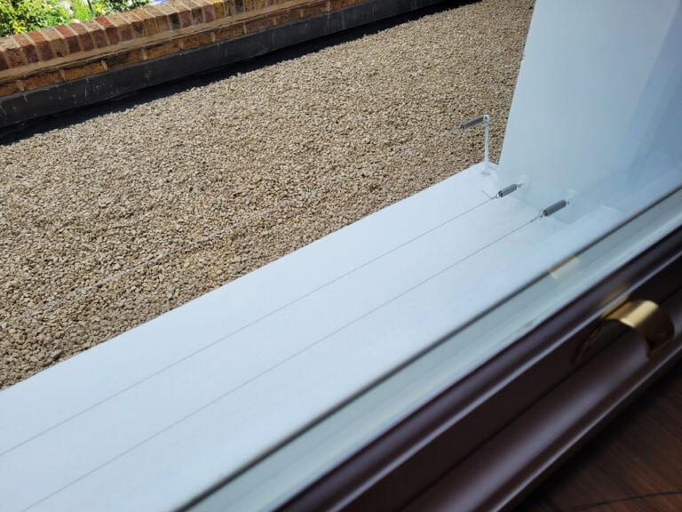 Pin and wire bird deterrent installed on the window ledge of a domestic property