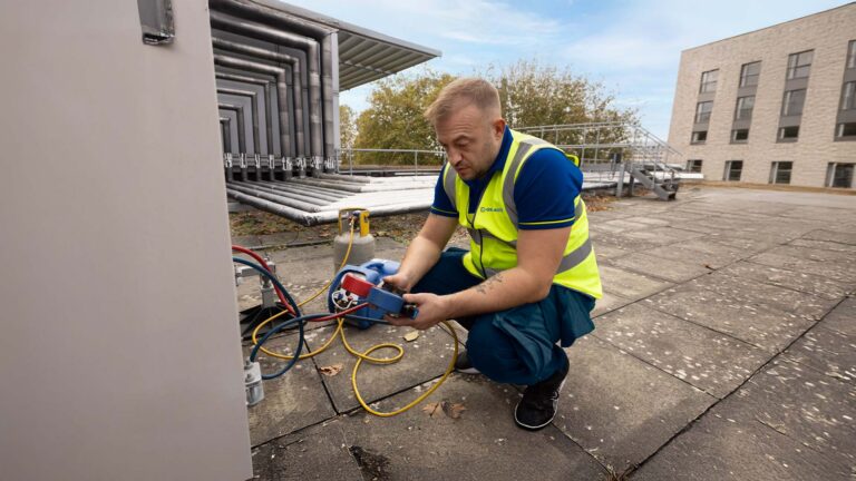 An Aspect air conditioning specialist checks refrigerant levels as part of a set of recurring maintenance checks