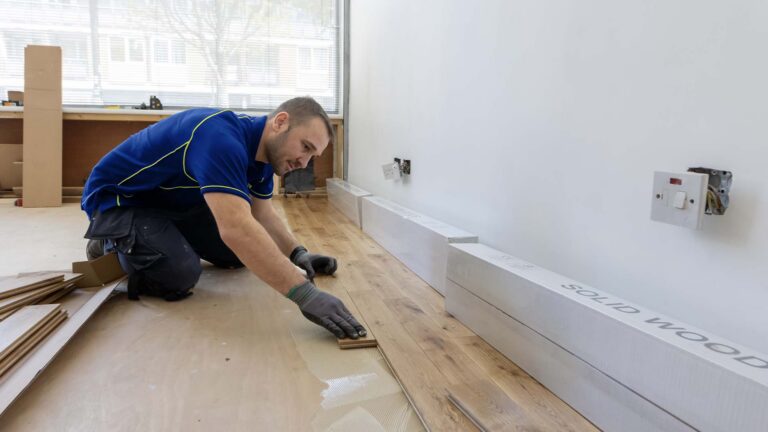 An Aspect carpenter fitting a solid wood floor in a new shop