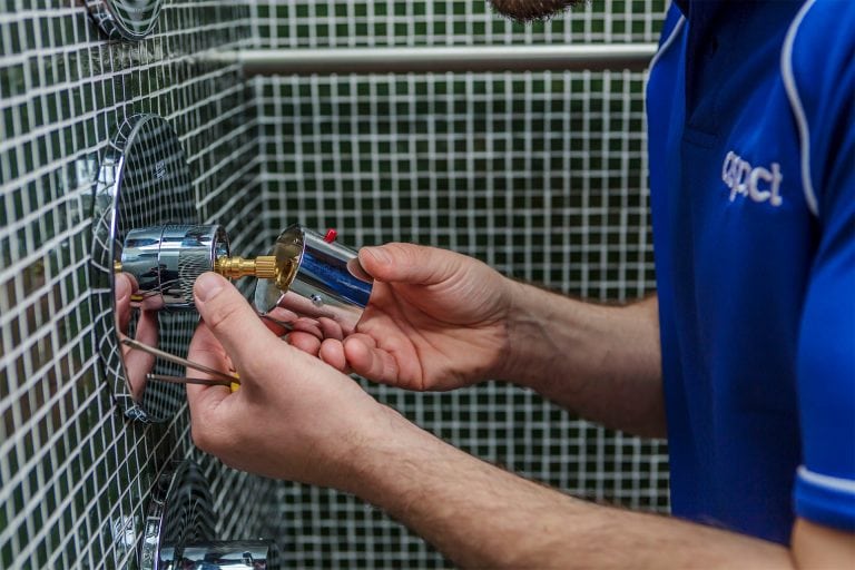 An Aspect plumber replaces the thermostatic cartridge in a shower control.