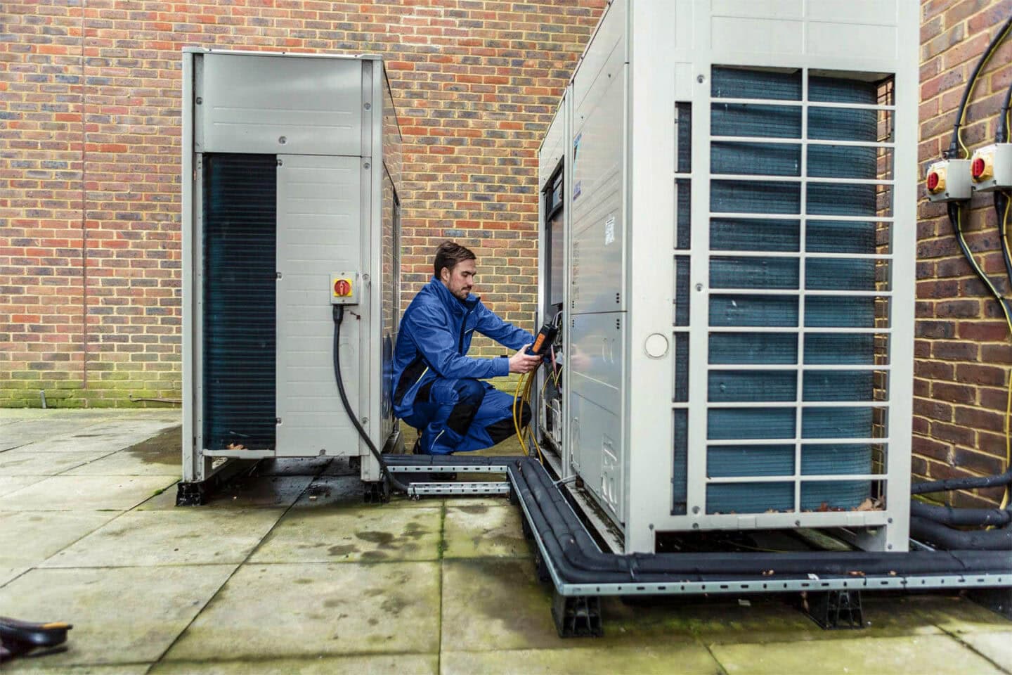 Aspect Engineer servicing large outdoor air conditioning units